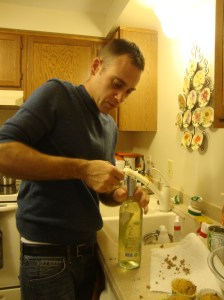 J working away at the wine cork with a knife